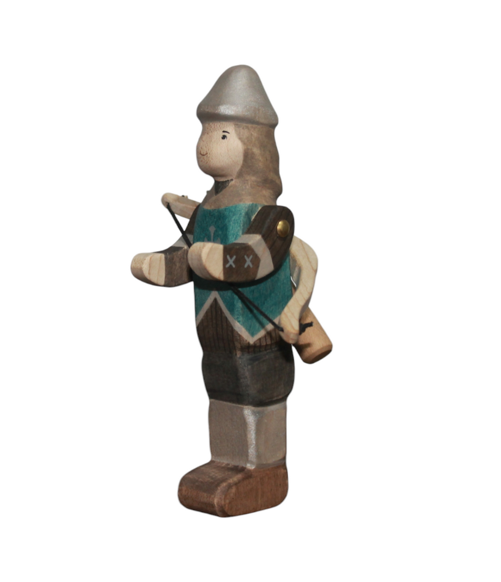 Side view of jointed Batang Kahoy Wooden Archer figurine in teal tabard holding a bow with a back quiver. Maple wood.