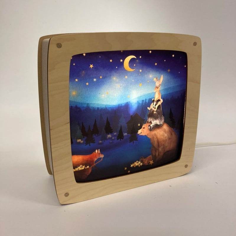 Magic Lamp silhouette "Hanging Stars" by Lotte Drouen featuring a bear, badger, rabbit stacking up to reach the moon & stars