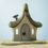 Thumbnail: Bumbu Toys Handcrafted wooden witch's hut toy with cobweb accents.