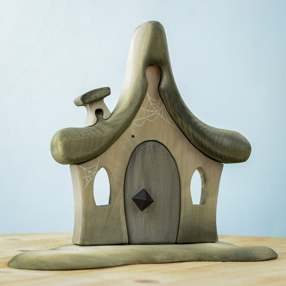 Bumbu Toys Handcrafted wooden witch's hut toy with cobweb accents.