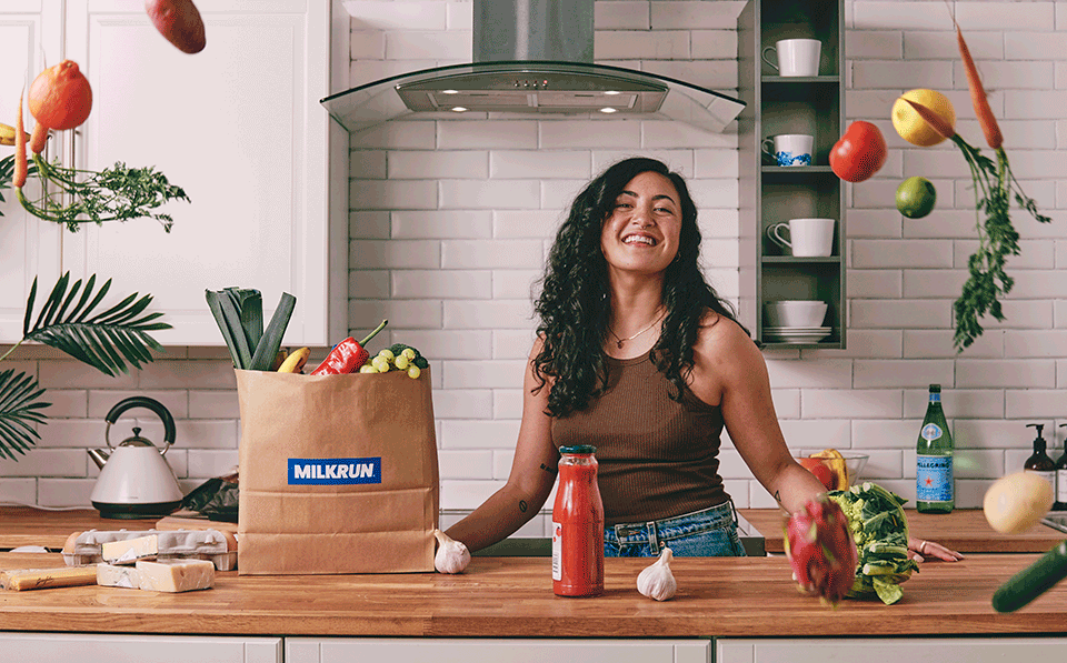 MILKRUN bag of groceries delivered to customer in minutes with groceries falling. Favourite brands in the kitched ordered through the MILKRUN app