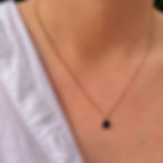 gold chain with black circular pendant necklace (selena necklace) on model