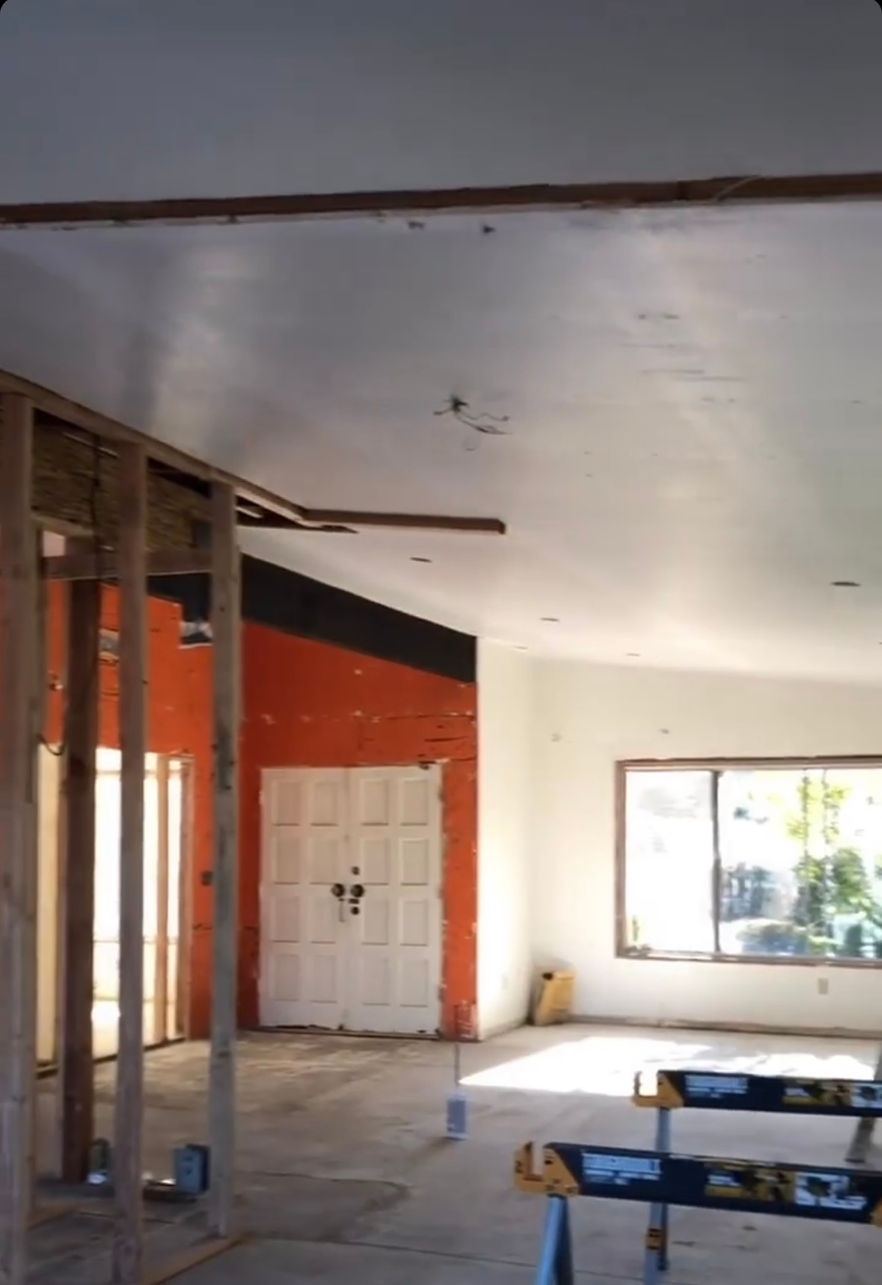 Building under construction with scaffolding and workers.