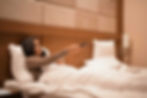 woman-in-bed-at-night-watching-television-and-hold