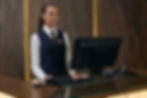 receptionist-working-on-computer-in-the-hotel