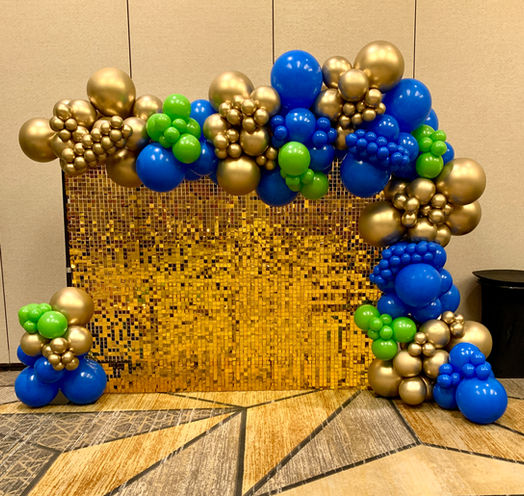 gold shimmer wall backdrop with balloons for event in downtown San Antonio