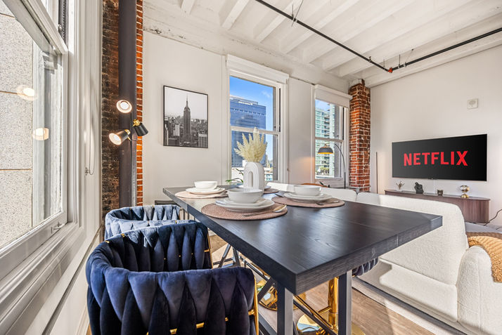 Modern dining area, Netflix TV, city view. furnished apartment san diego. Celeste & Co.