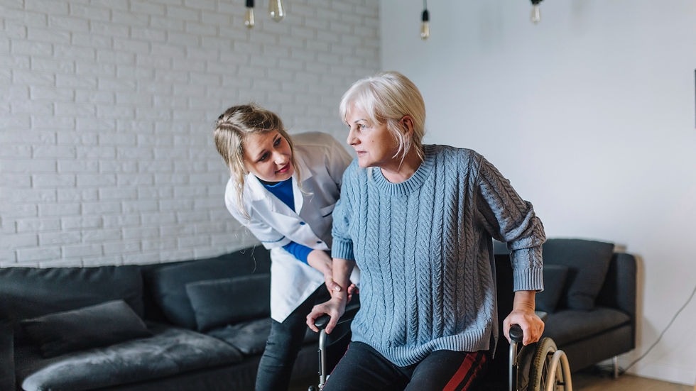 Nurse helping an elderly woman to stand up.