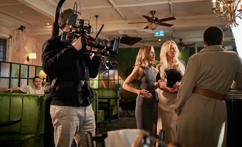Cameraman filming two women talking in a restaurant