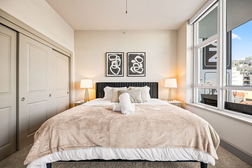Cozy bedroom with bed, lamps, and art on the wall, short-term rental management.