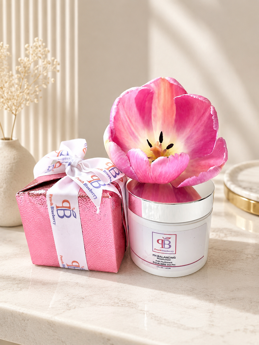 Pink gift box and PeachBlueberry PH Balancing lifestyle cream with a tulip