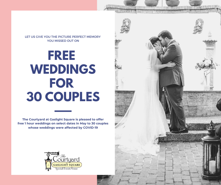 A bride and groom's first kiss at their outdoor wedding ceremony in front of a fountain