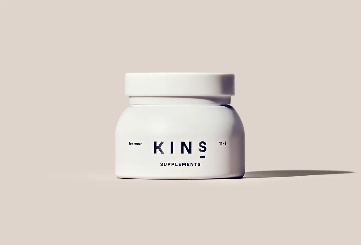 A bottle of probiotic supplements by KINS for gut and skin health