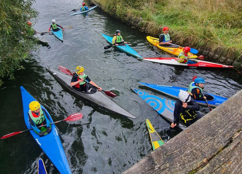 Kayakers paddling on calm river