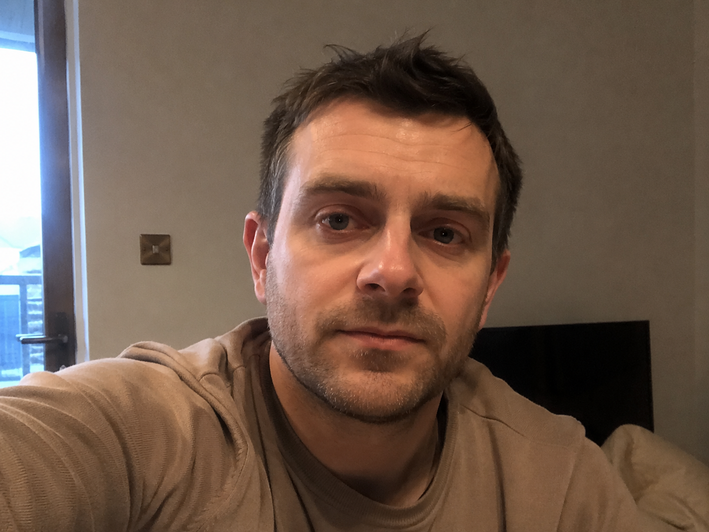 Man with short dark hair and light beard