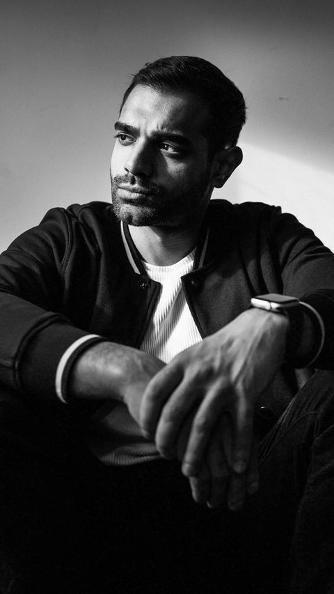 A Male actor wearing a jacke edited in black and white