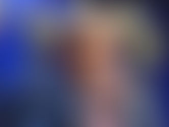 Donald Trump points directly toward the audience while speaking, framed by U.S. flags, symbolizing his assertive stance on immigration and foreign policy.