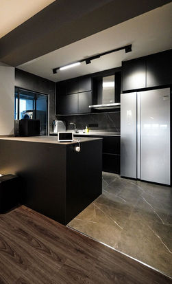 A kitchen black marble tiles modern interior in Singapore.