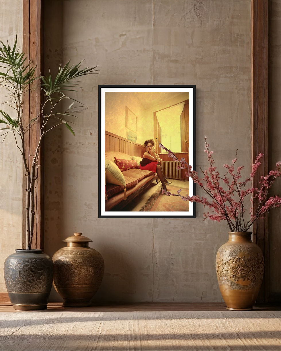 Photograph of a woman in a black top and red skirt sitting on a couch in a framed picture