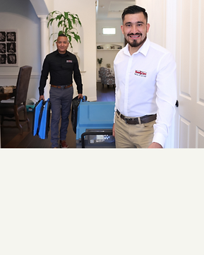 SteamCare Technician carrying water damage equipment