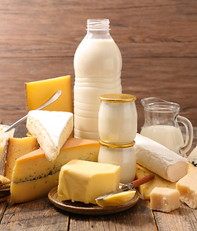 Cheese and bottles of milk on a table
