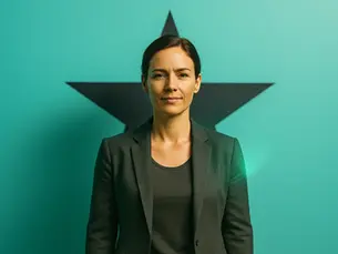 A stand out woman, standing confidently against a teal background with a black star symbolic of the book by Debra Stevens. Wearing a dark blazer, she expresses a calm, assertive mood knowing her Human Skills are what got her here.