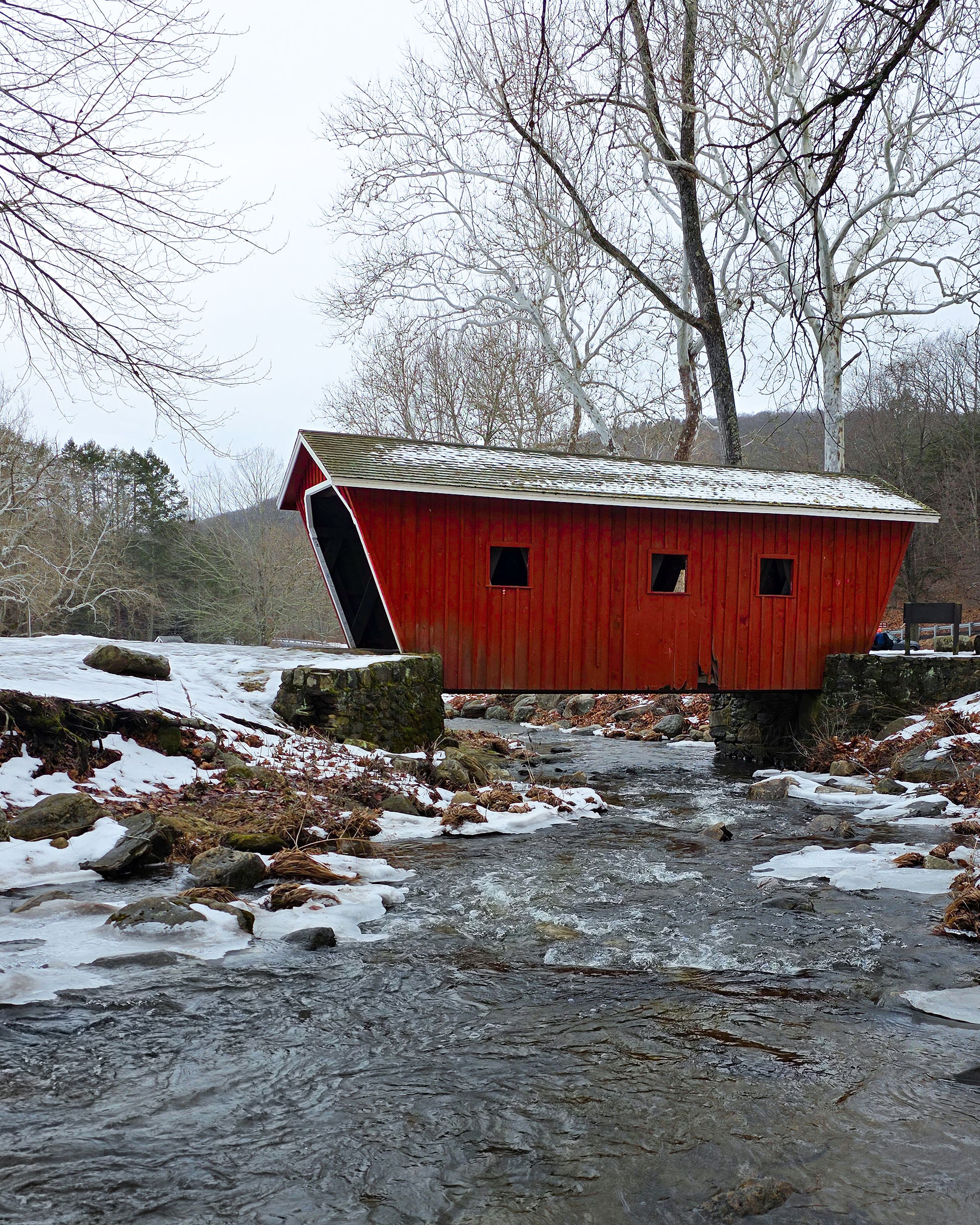 View of red covered bridge in Kent, Connecticut in the winter