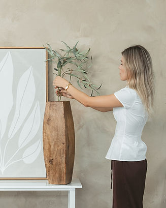 Property stylist arranging decor in a home staging project