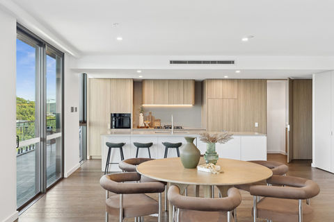 Modern kitchen and dining area with wooden accents.