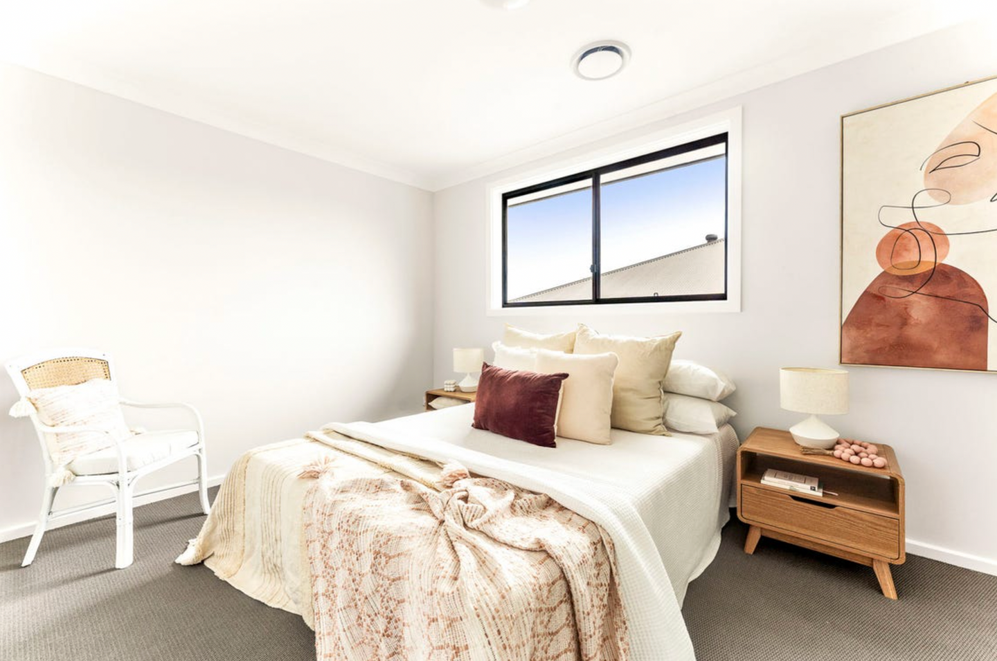Contemporary guest bedroom with soft neutral interiors and natural lighting