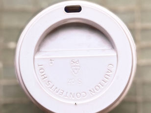 A white plastic coffee cup lid