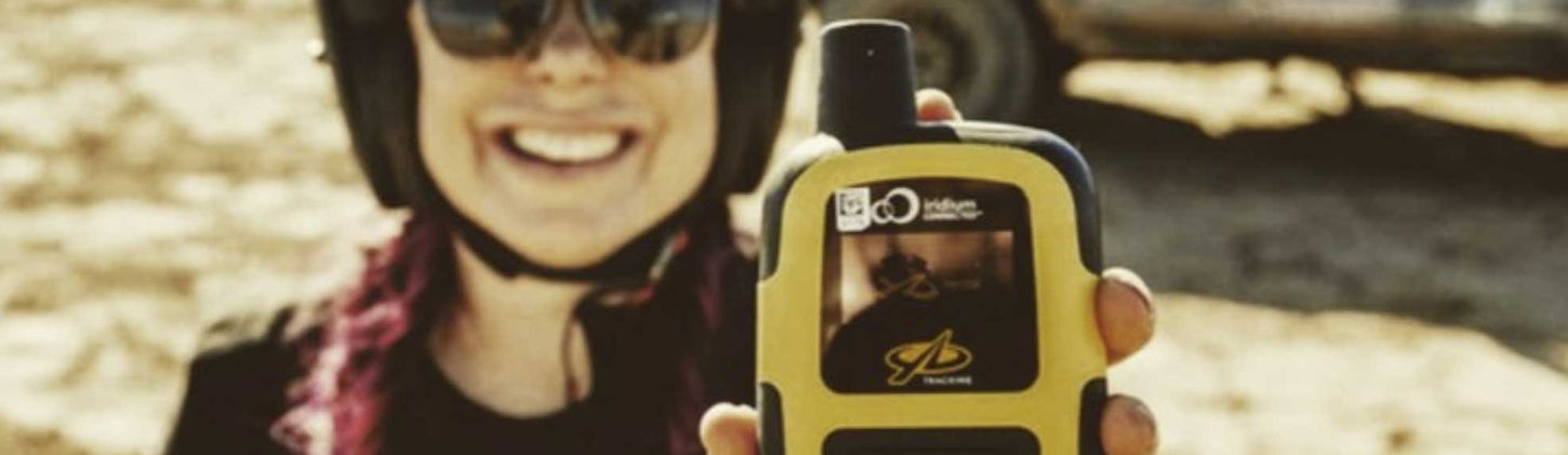 A woman holding a YB3 tracker