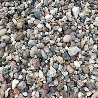 Closeup shot of red, grey, brown, white, and yellow rainbow river landscaping rock