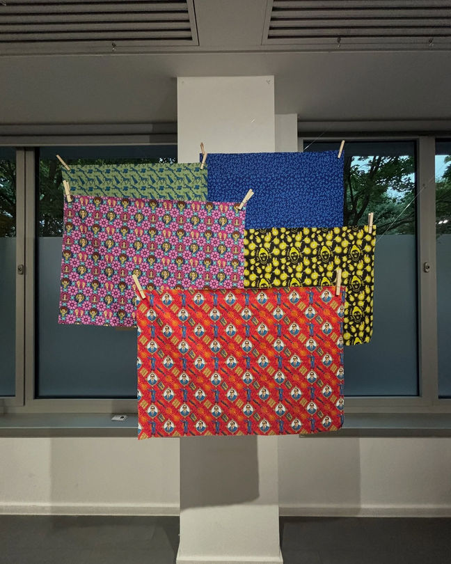 a bunch of colorful cloths are hanging on a clothes line