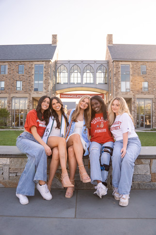 college friends smiling on campus