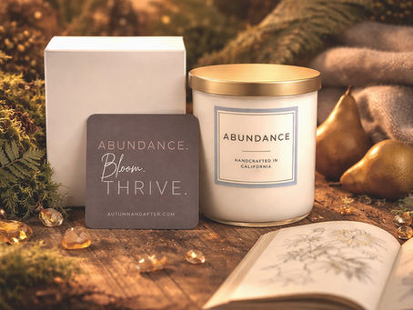 Autumn & After Abundance candle pictured with box and "Abundance, bloom, thrive." affirmation card