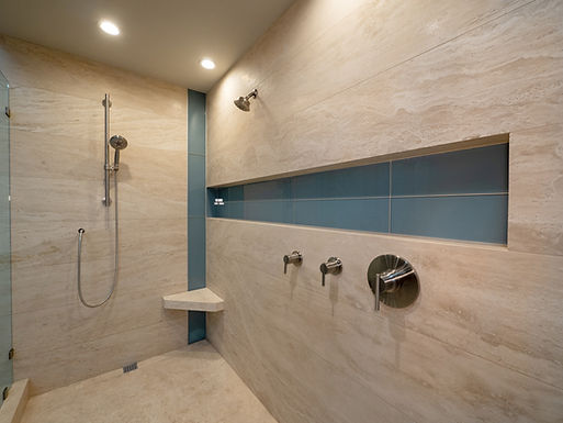 Roman travertine bathroom wall cladding and shower surfaces in modern interior design
