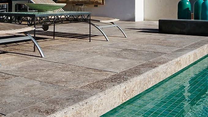 Roman travertine pool surround stone around an outdoor swimming pool
