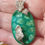 Thumbnail: Green oval cabochon with silver leaves