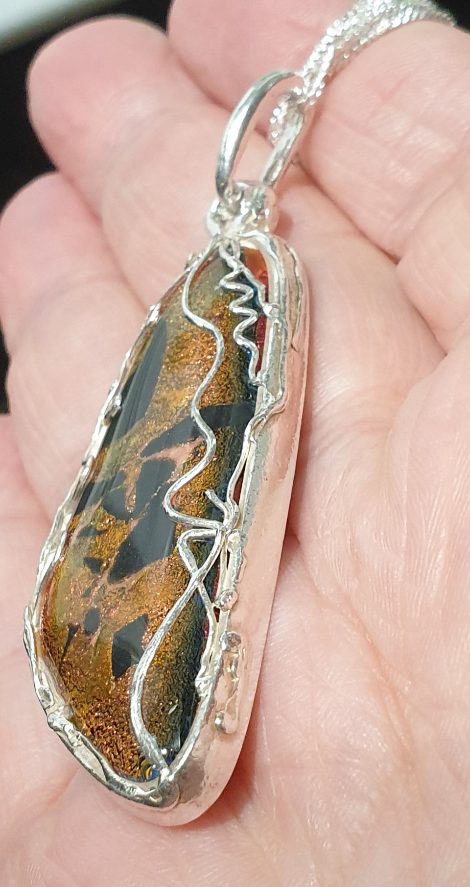 Thumbnail: Silver surround bronze cabochon filigree strands
