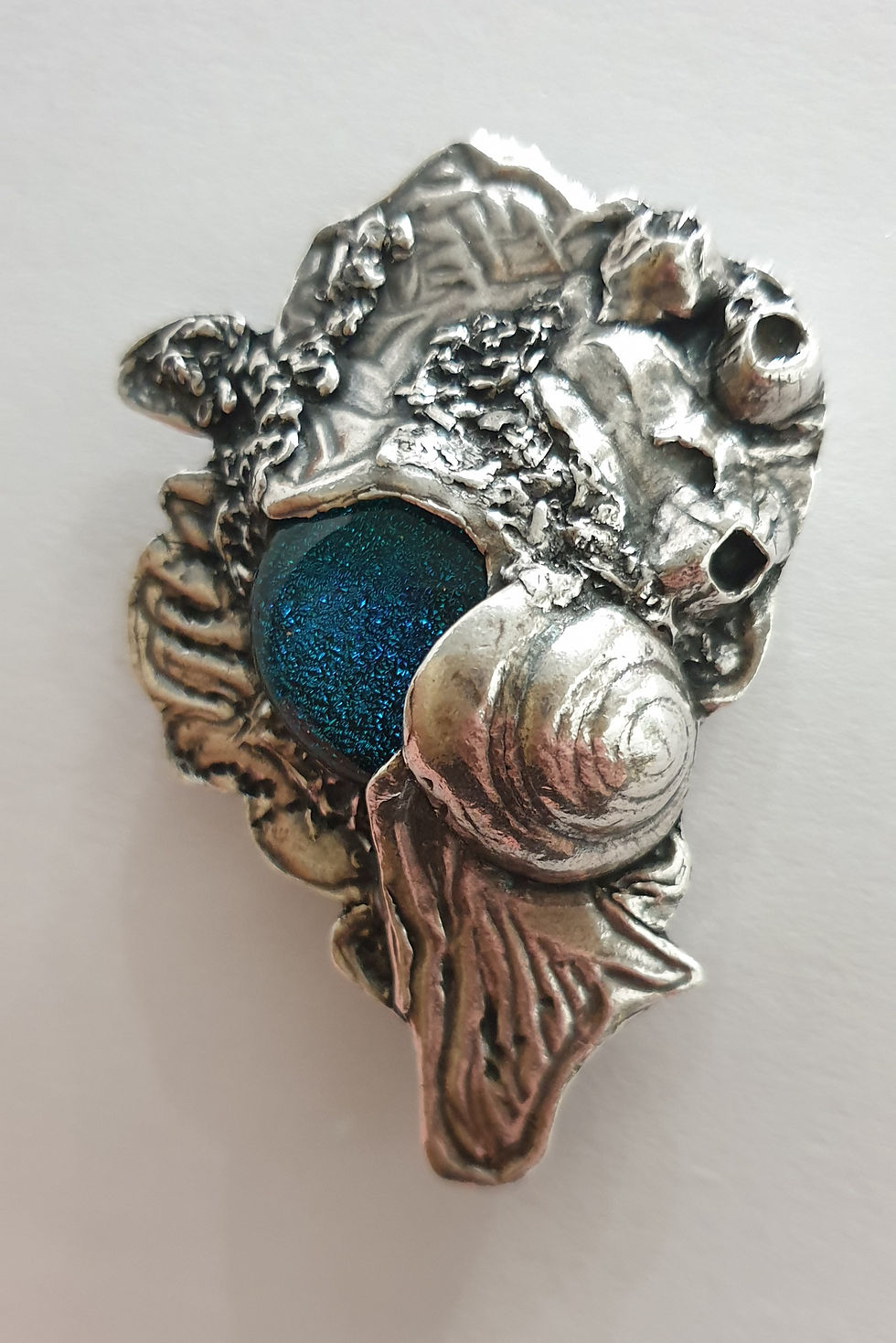 Thumbnail: Large silver brooch depicting sea life around a blue cabochon