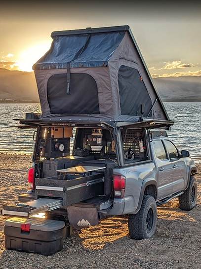 Toyota Tacoma 5' bed with Fahrt Systems camp kitchen and canopy interior cabinetry for overlanding inside a Lone Peak canopy camper for overland gear organization and cooking outdoors