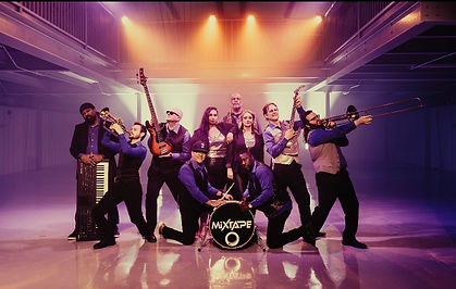 Jesse Baker with the cover band Mixtape posing for a cool cover band shot with their instruments in cool lighting