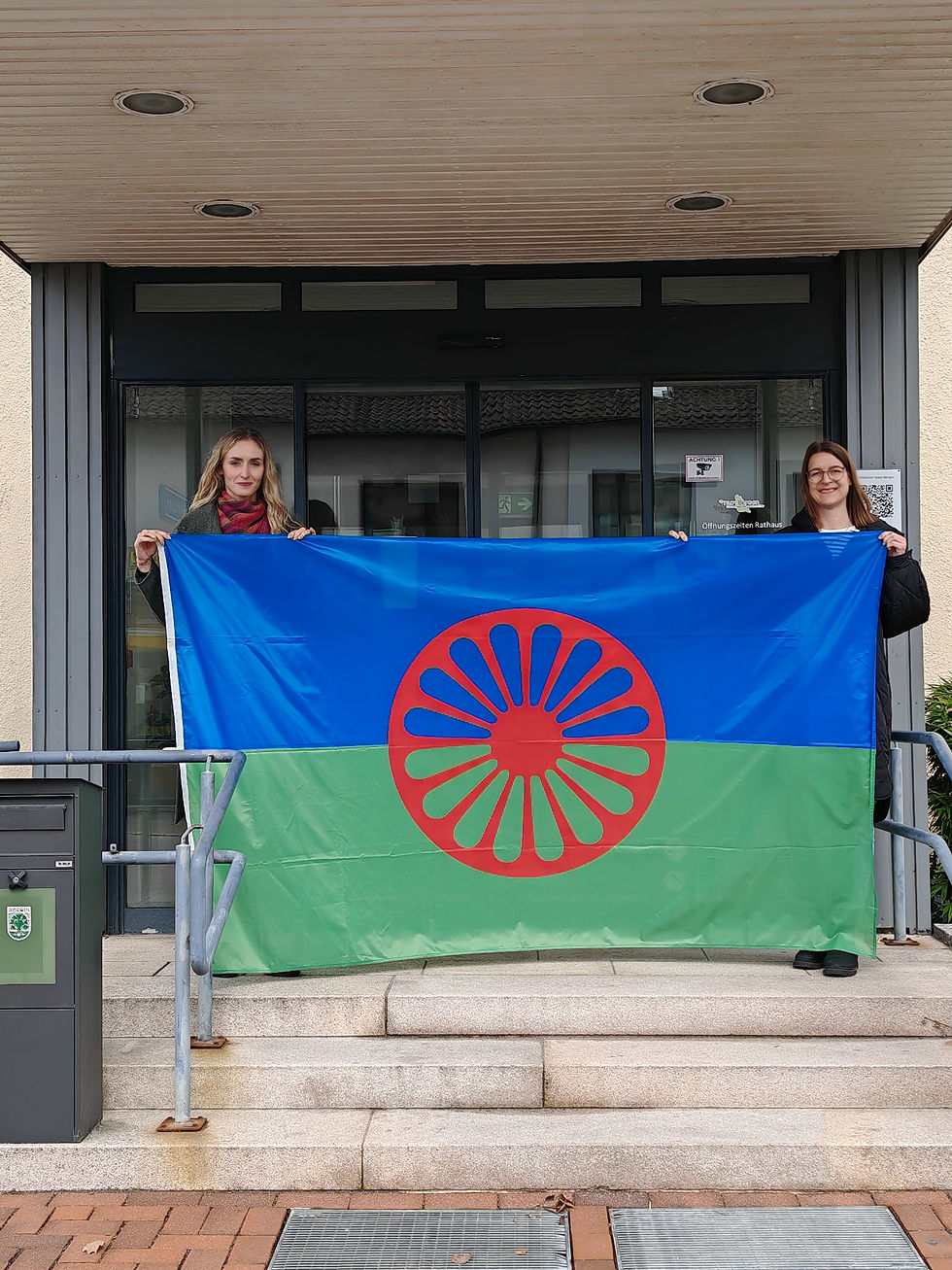 Mitarbeiterinnen der Stadt Bergen mit der Roma-Flagge vor dem Rathaus / Copyright Stadt Bergen).