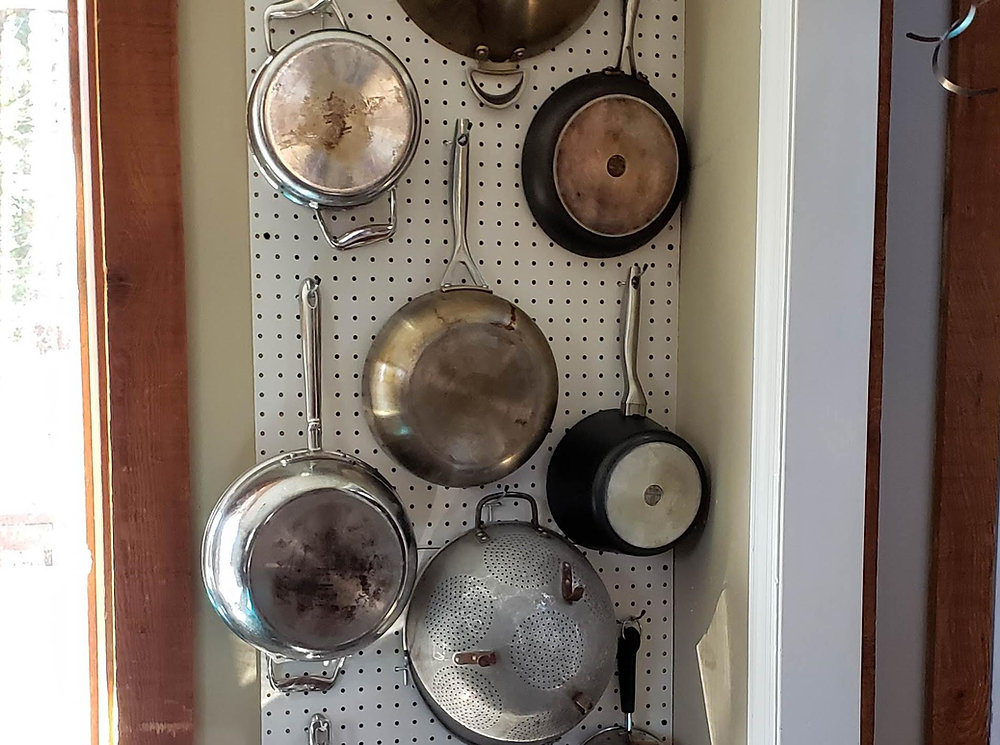 Tip Hang Pots and Pans on Pegboard to Maximize Space