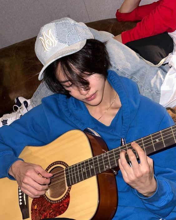 Playing acoustic guitar