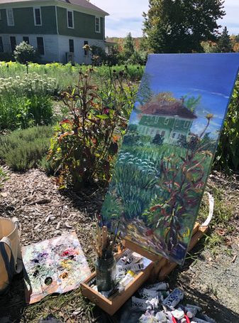 Green and white farmhouse with garden and large foreground echinacea