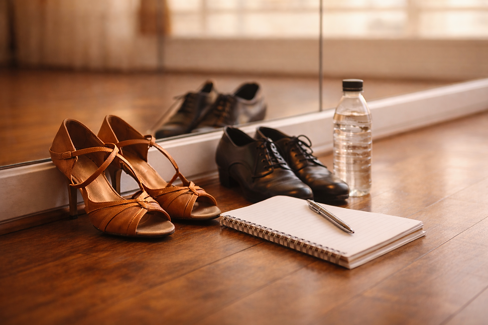 Dancesport shoes, water bottle and note book in a dance studio setting