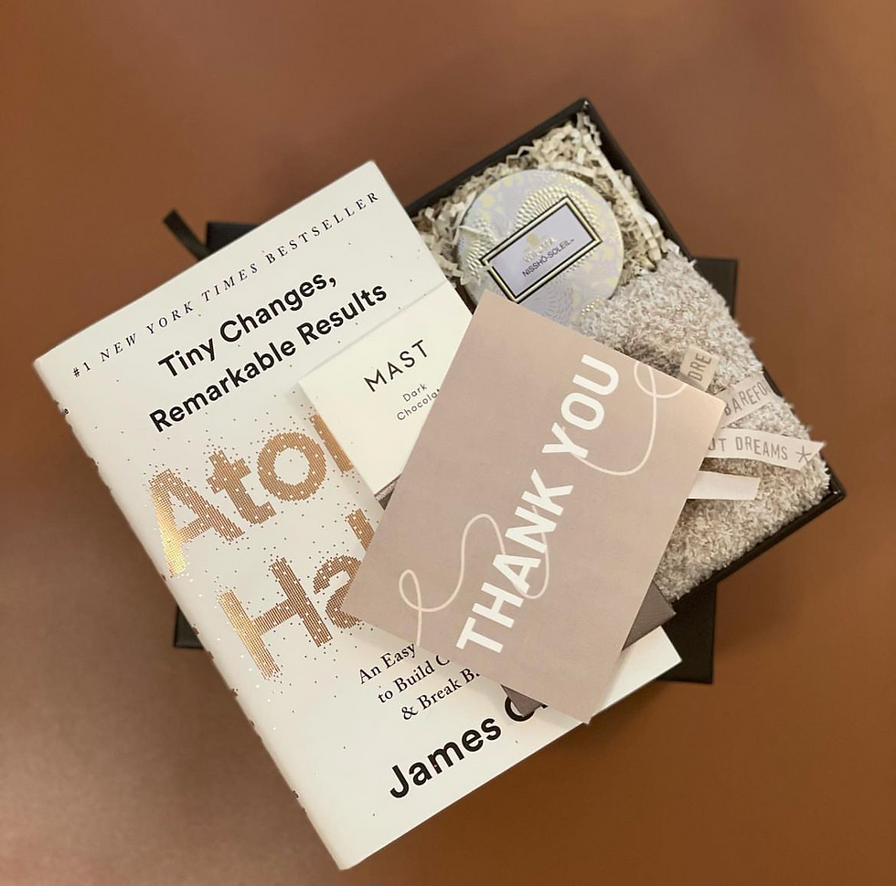 Close-up view of a self-care gift box with candles and bath bombs