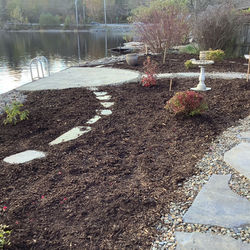 A no lawn garden setting beside the lake with half moon patio afforing a gorgeous view up 